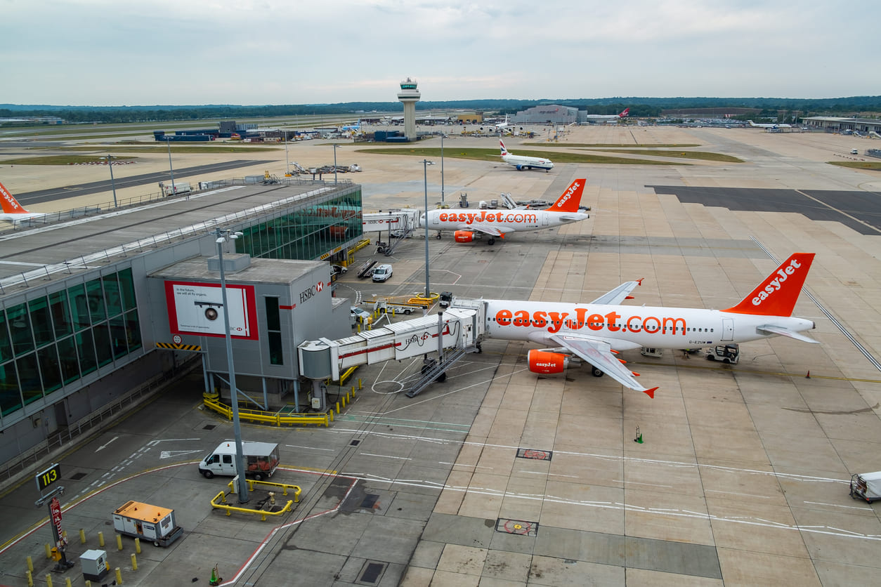 EasyJet planes parked at Gatwick Airport's terminal, highlighting the airport's busy operations and modern facilities.