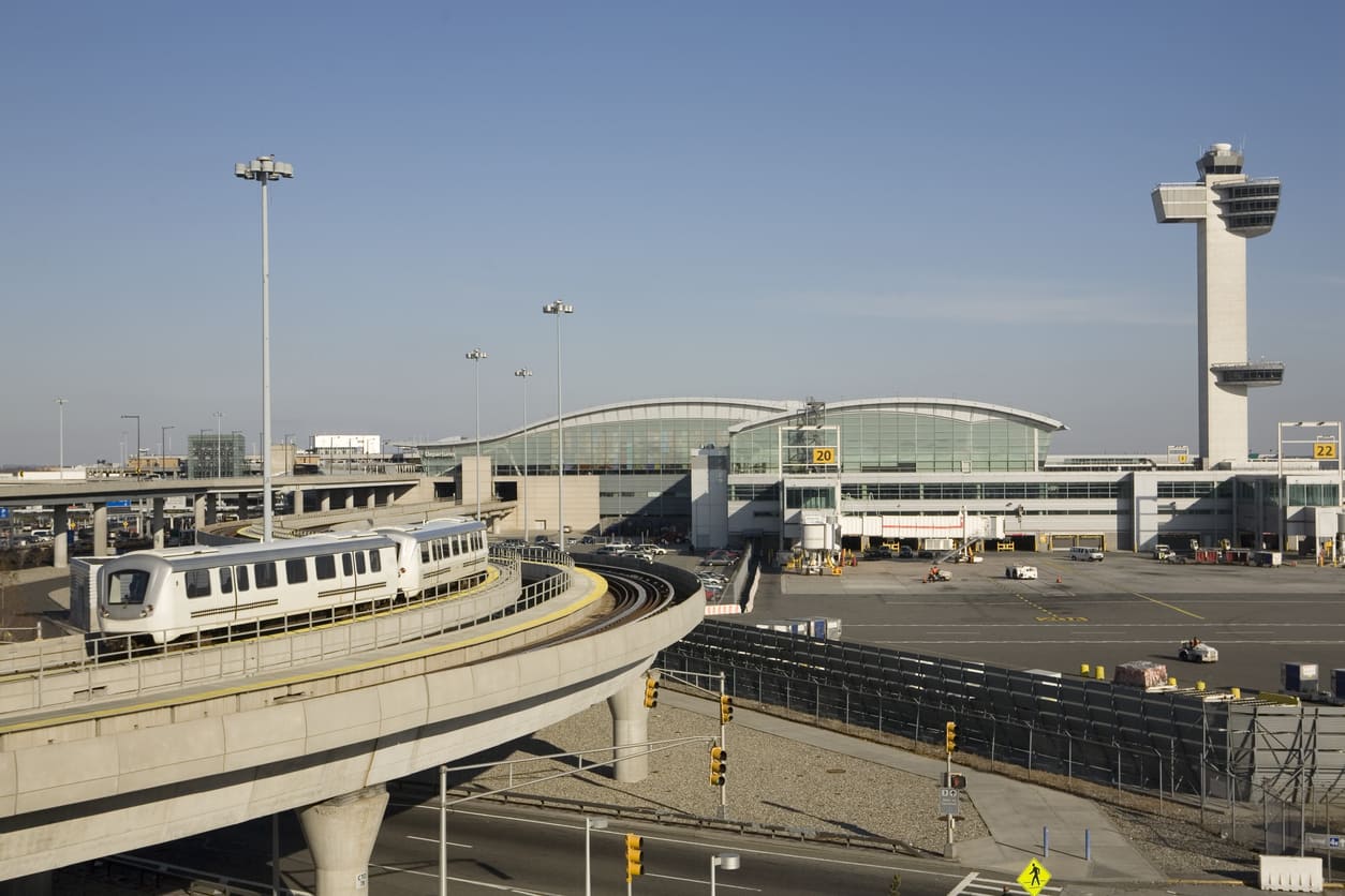 John F. Kennedy International Airport with its modern terminal, control tower, and AirTrain system in Queens, New York.