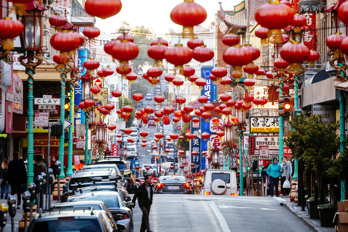 San Francisco's Chinatown adorned with red lanterns, bustling with activity and festive decorations for Lunar New Year.
