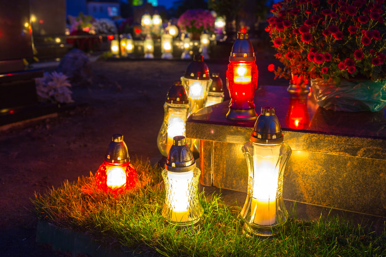 A cemetery glowing with candlelight, reflecting remembrance, prayer, and respect for departed souls on All Souls' Day.