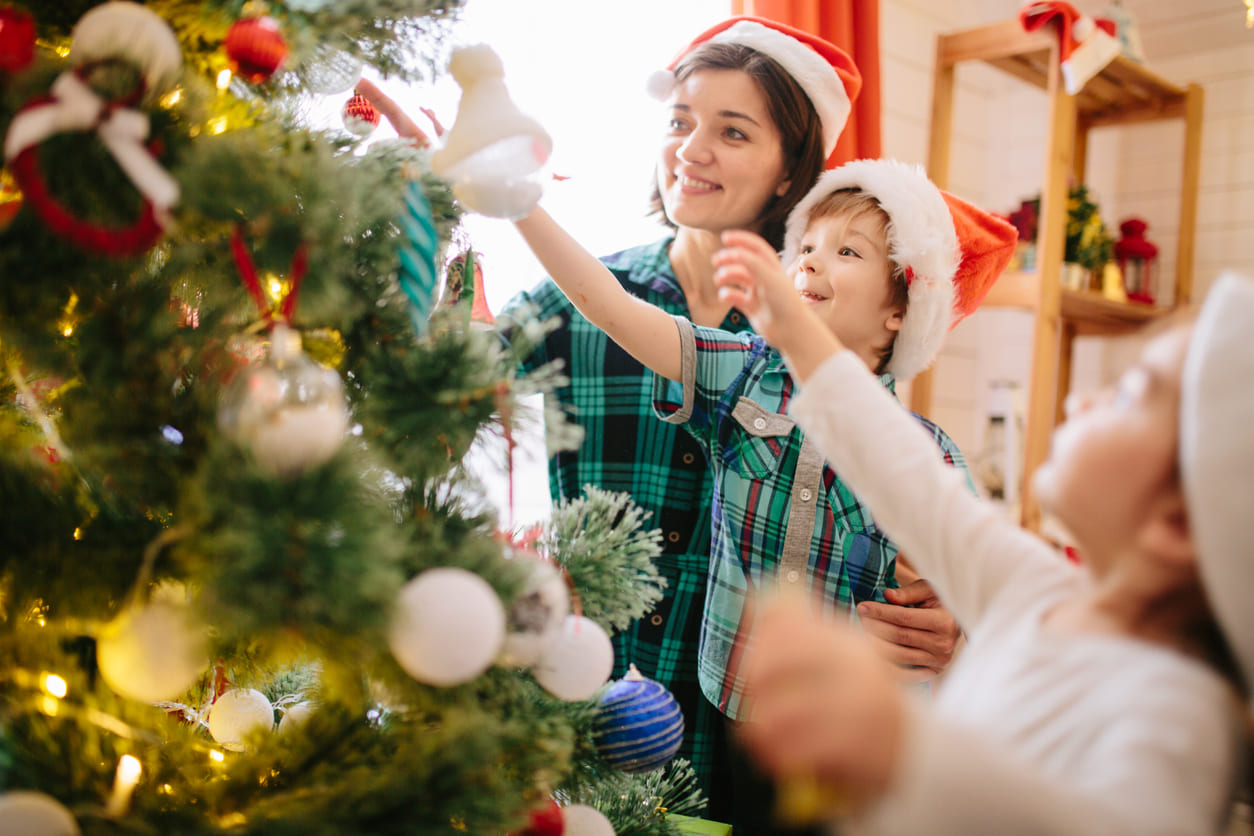 A family joyfully decorates their Christmas tree on Christmas Eve, embracing the festive spirit and anticipation of Christmas Day in Australia.