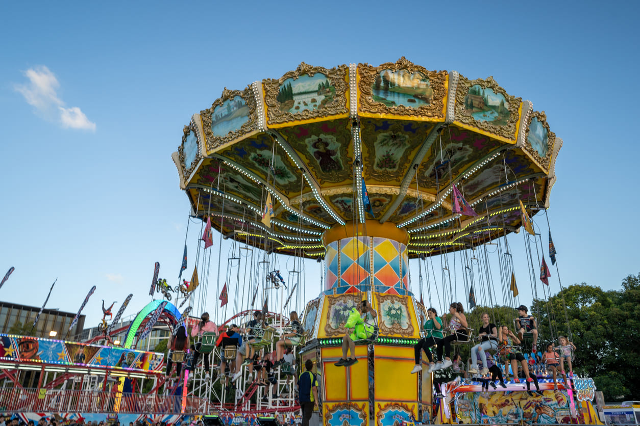 A lively scene at the Sydney Royal Easter Show on Easter Monday, with families enjoying carnival rides, festivities, and vibrant entertainment.