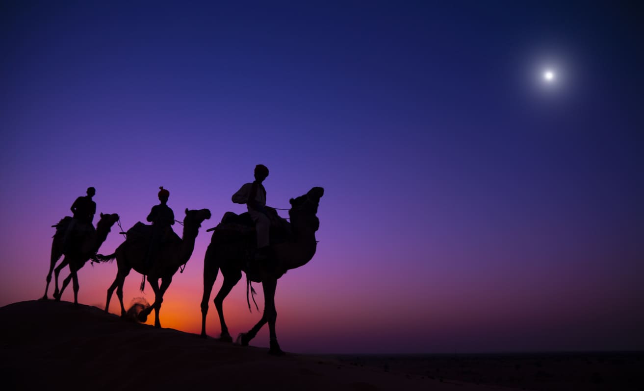 A silhouette of the Three Wise Men on camels traveling under a glowing star, representing the journey celebrated on Epiphany in Australia.