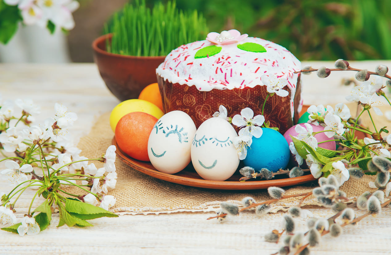 A vibrant Easter arrangement with decorated eggs, sweet bread, and blooming flowers, capturing the festive spirit of Orthodox Easter Monday.