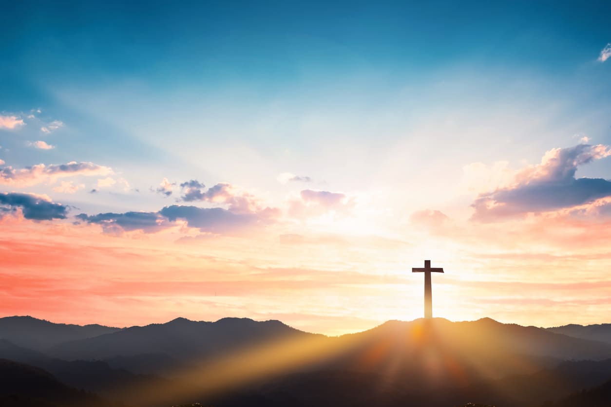 A cross on a hilltop against a glowing sky, capturing the solemn and spiritual essence of Orthodox Good Friday.
