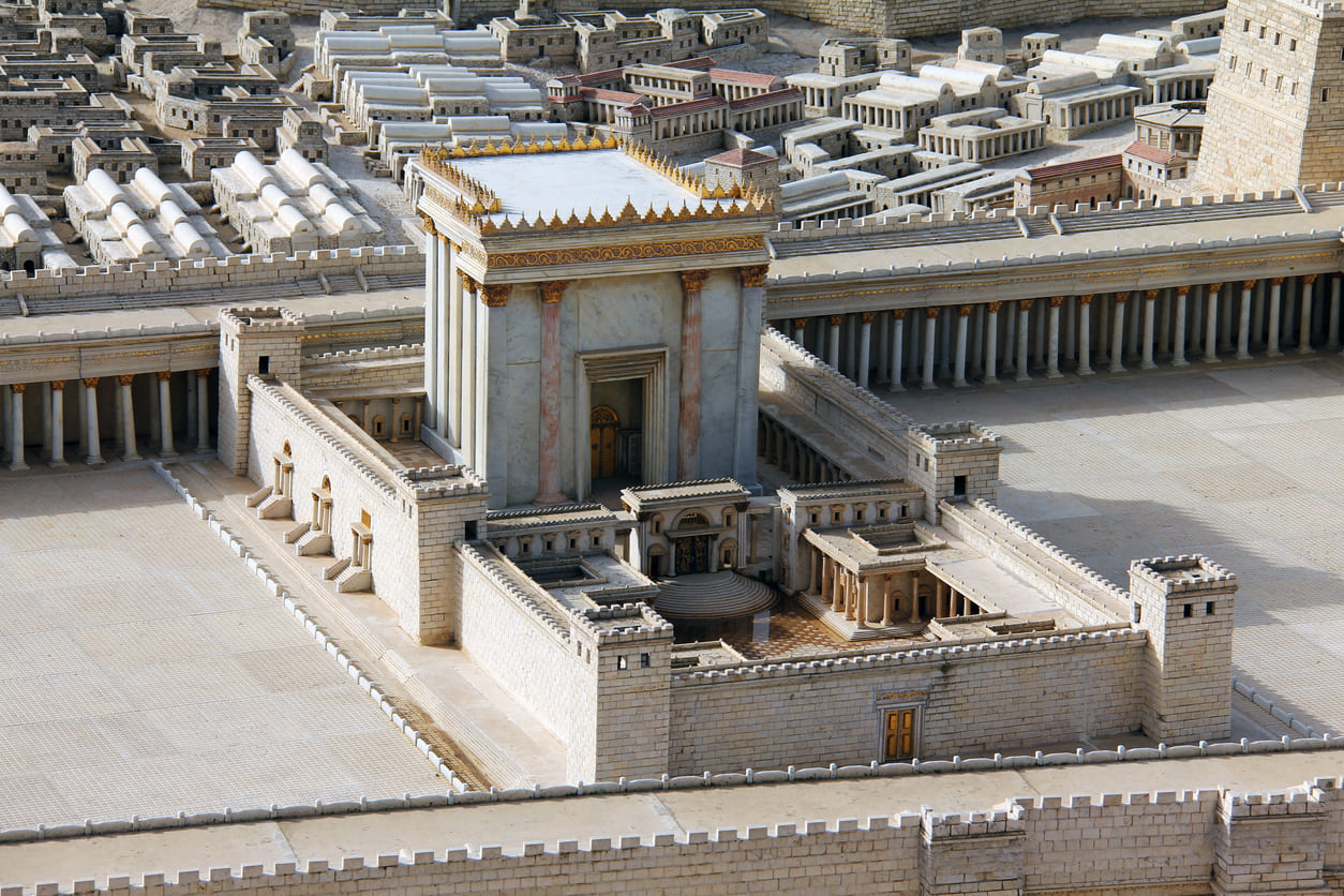 A detailed architectural model of the Second Temple, surrounded by ancient-style structures, highlights the grandeur of what was lost on Tisha B'Av.