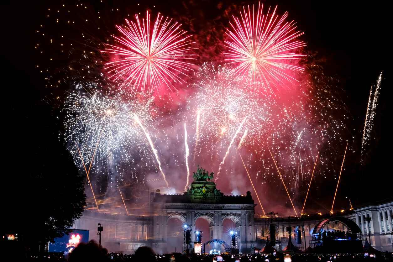 A dazzling display of fireworks illuminates The Triumphal Arch at Cinquantenaire Park in Brussels, celebrating Belgian National Day with grandeur.