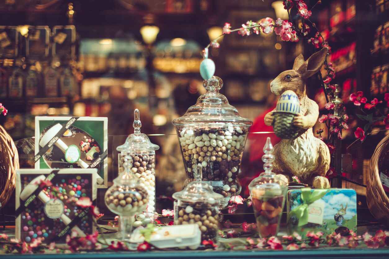 A charming Easter display with chocolates, glass jars, and a festive bunny.