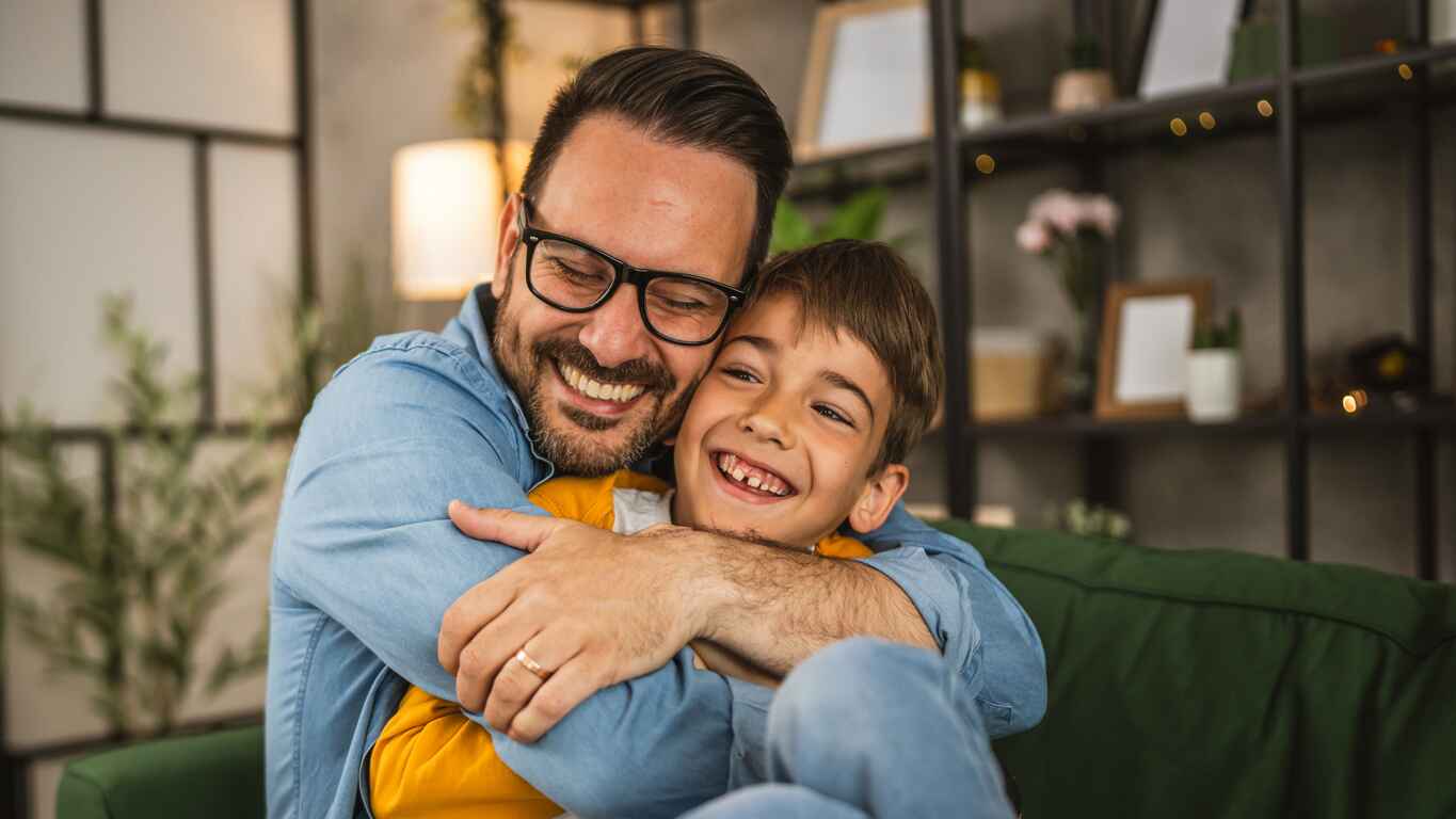A heartwarming Father's Day scene of a father and son sharing a joyful embrace, celebrating their special bond.