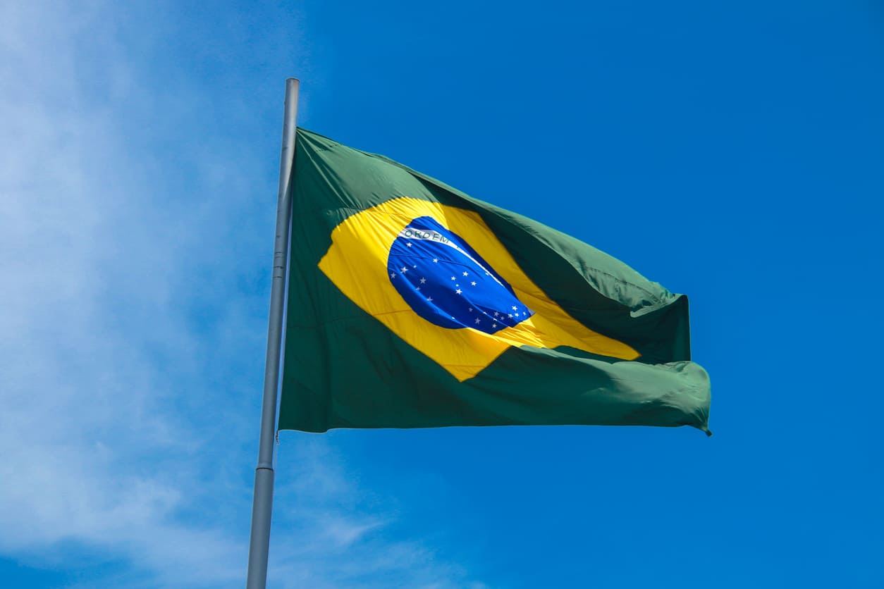 The Brazilian flag waving against a bright blue sky, reflecting national pride and the spirit of Republic Proclamation Day.