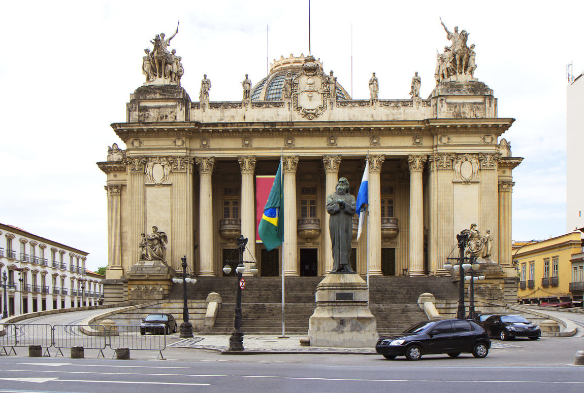 Tiradentes Palace in Rio de Janeiro, a grand neoclassical building with statues, columns, and the prominent statue of Tiradentes at the front.