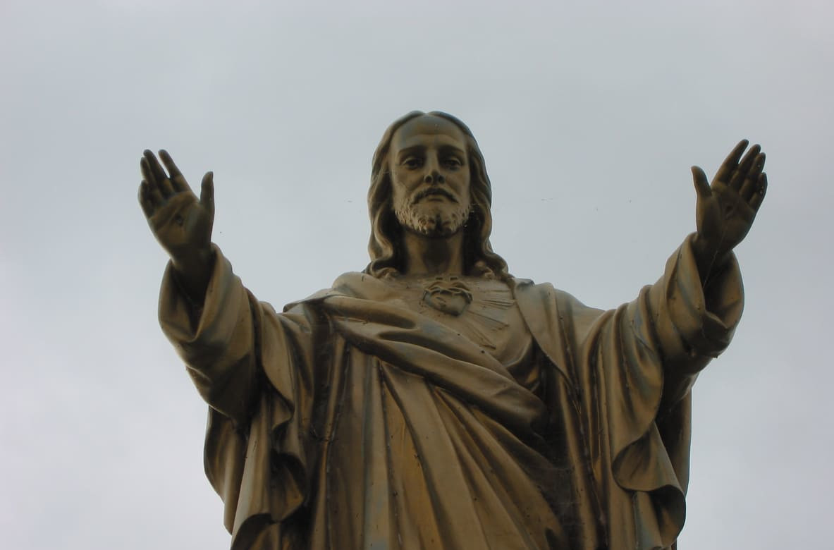 A statue of Jesus Christ with open arms, representing his ascension into heaven, a central belief commemorated on Ascension Day.