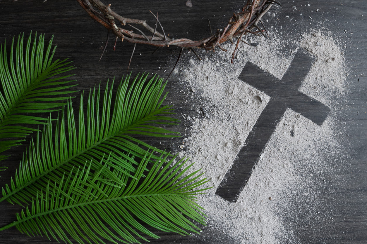 Ash Wednesday with palm leaves, a crown of thorns, and a cross outlined in ashes, representing repentance, faith, and the beginning of Lent.