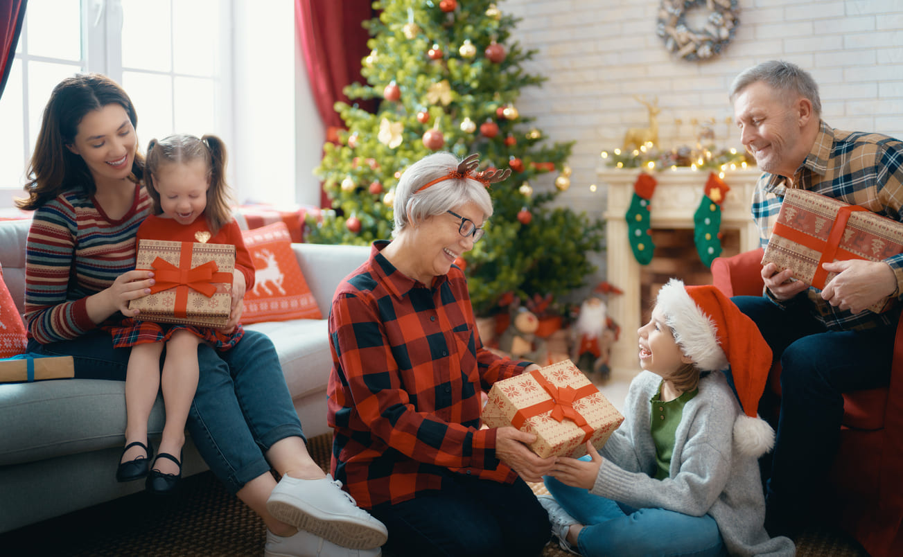A family gathered around a beautifully decorated Christmas tree, exchanging gifts and sharing festive joy on Christmas Day.