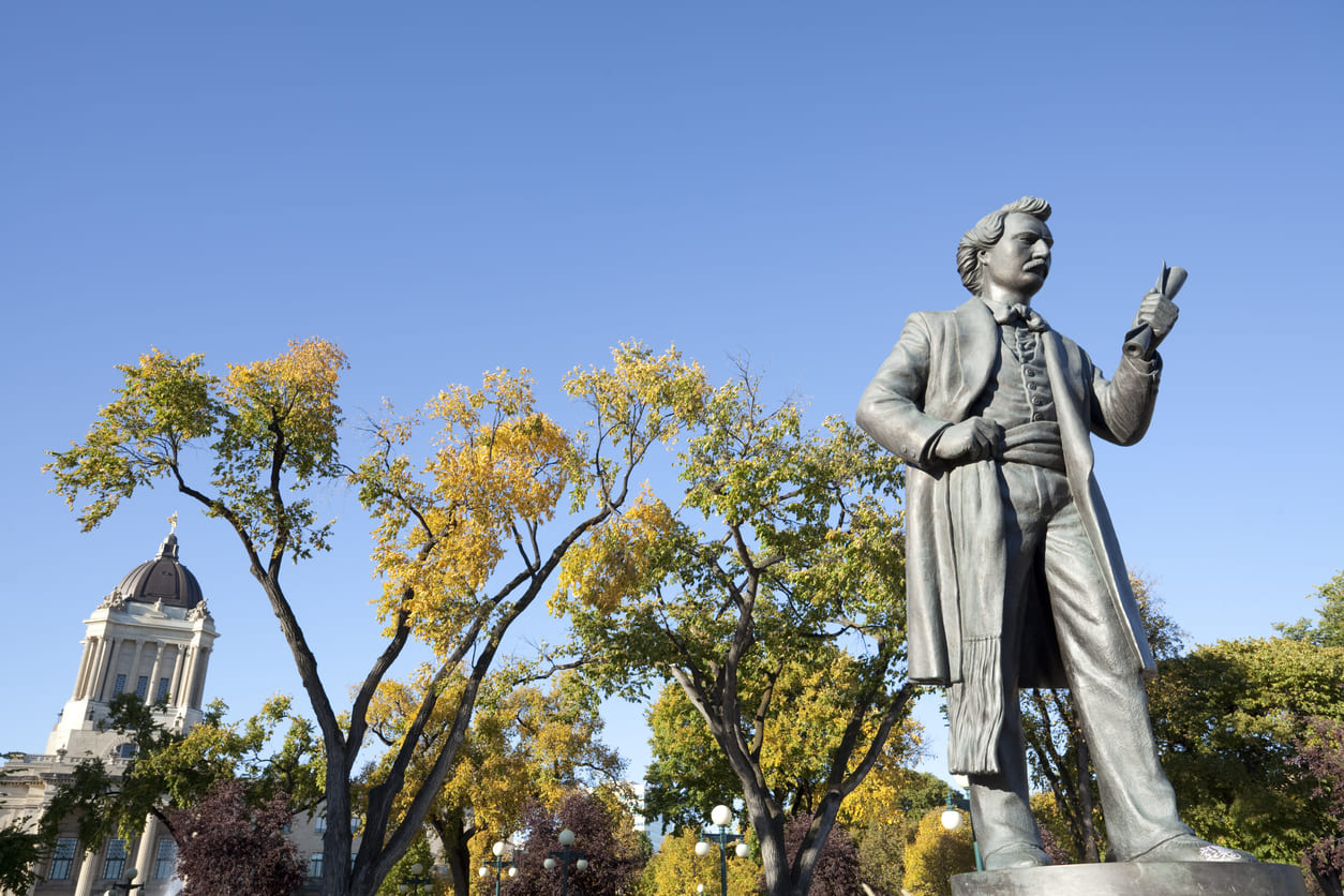 A bronze statue of Louis Riel stands proudly in Manitoba Legislative Building.