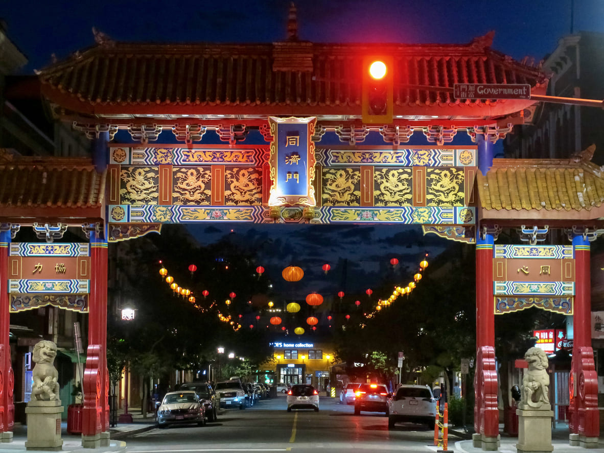 The beautifully lit Chinatown Gate in Victoria, British Columbia, Canada, decorated with red lanterns, symbolizes the vibrant Lunar New Year celebrations.