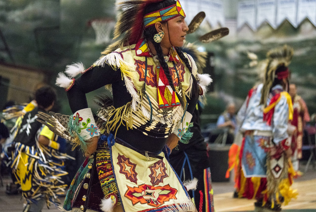 A Powwow dancer in vibrant traditional regalia performs during National Indigenous Peoples Day celebrations in British Columbia, Canada.