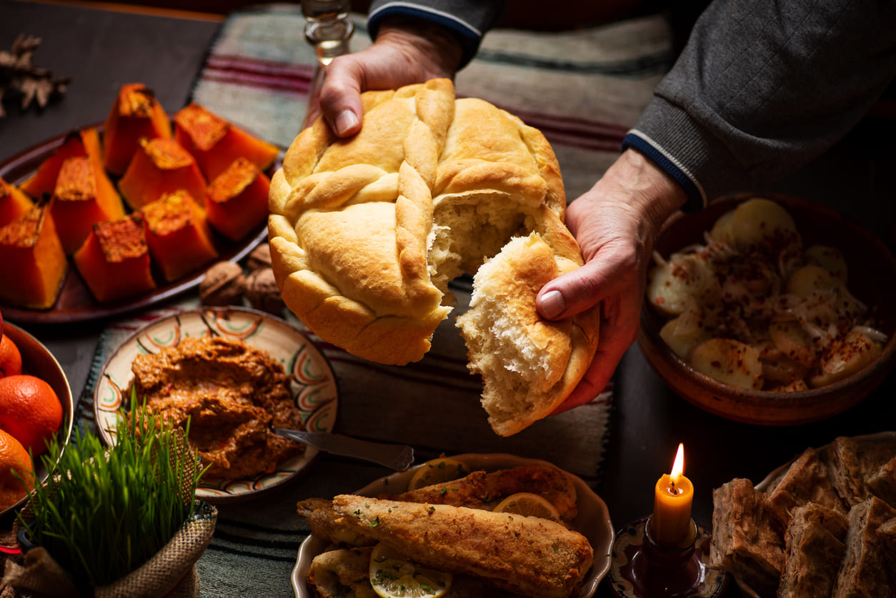 A traditional Orthodox Christmas feast with homemade bread, festive dishes, and candlelight, symbolizing faith, family, and togetherness.