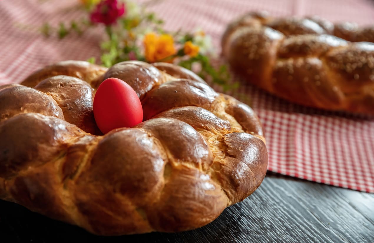 A beautifully braided Orthodox Easter bread with a red-dyed egg, symbolizing Christ's resurrection and the joy of Paschal traditions.