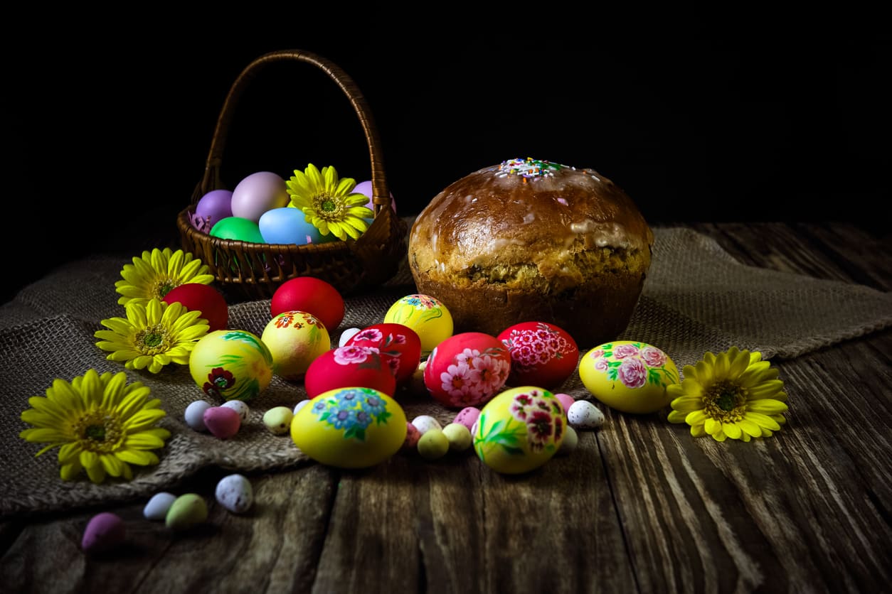 A festive Orthodox Easter arrangement with beautifully decorated eggs, traditional Easter bread, and vibrant spring flowers, symbolizing renewal and celebration.