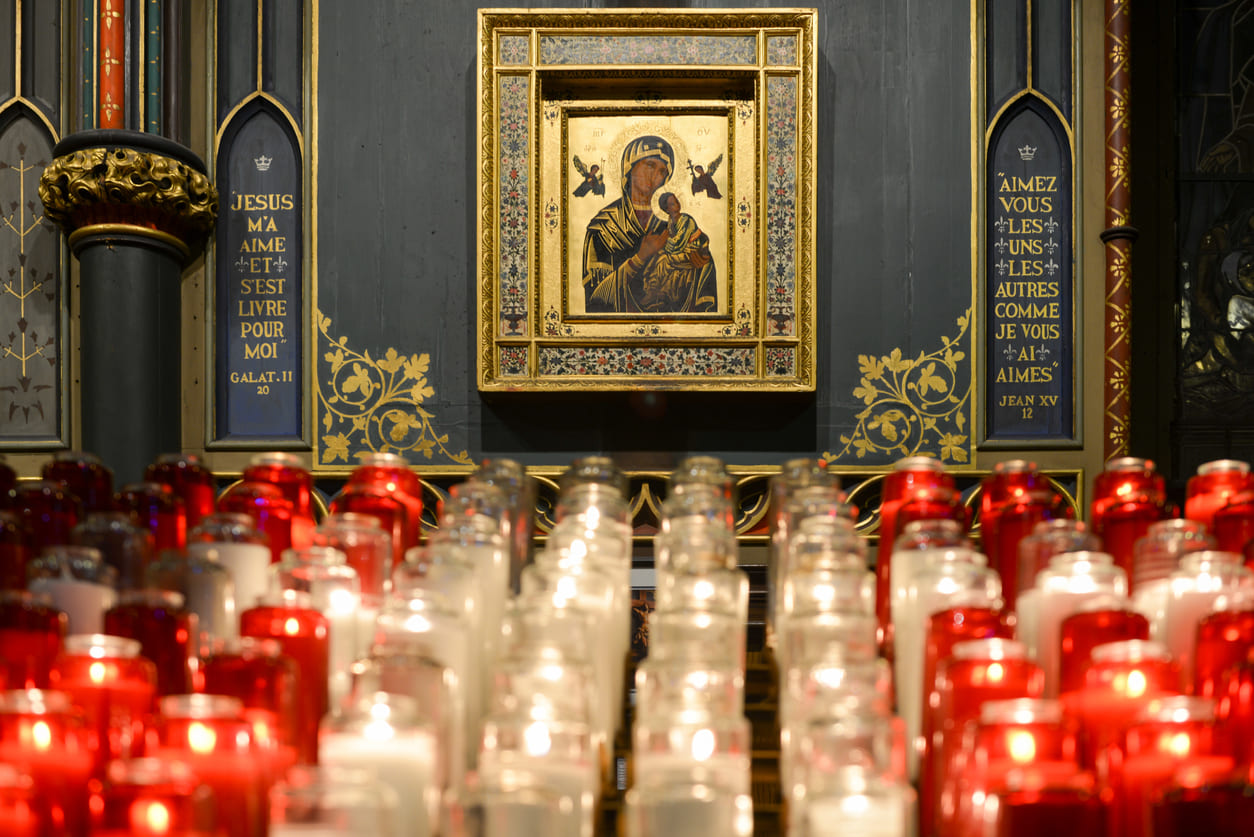 A sacred Orthodox icon surrounded by glowing candles, symbolizing prayers and blessings for the Orthodox New Year.