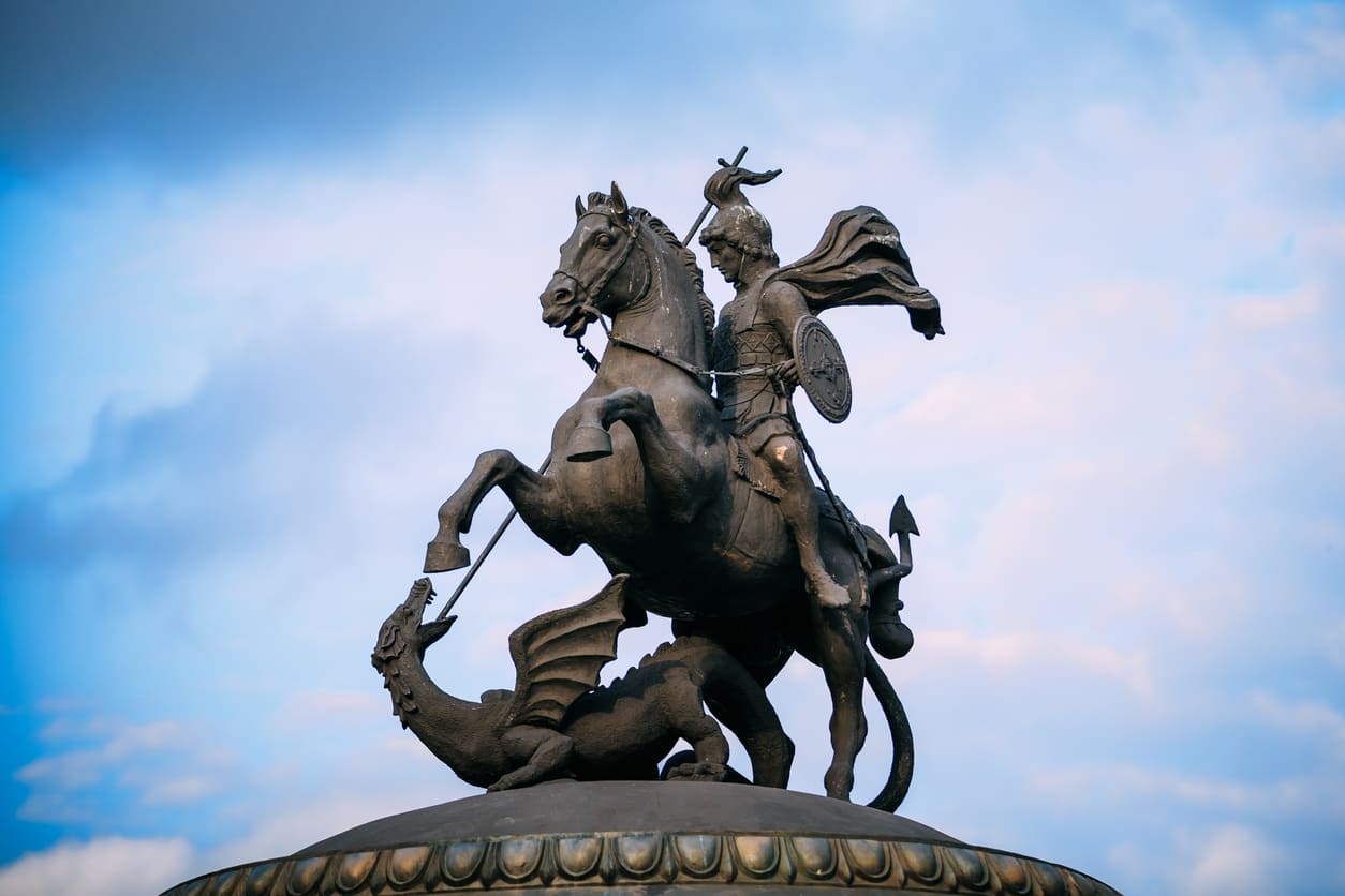 A bronze statue of Saint George on horseback, striking down a dragon, representing the legendary tale of courage and victory.