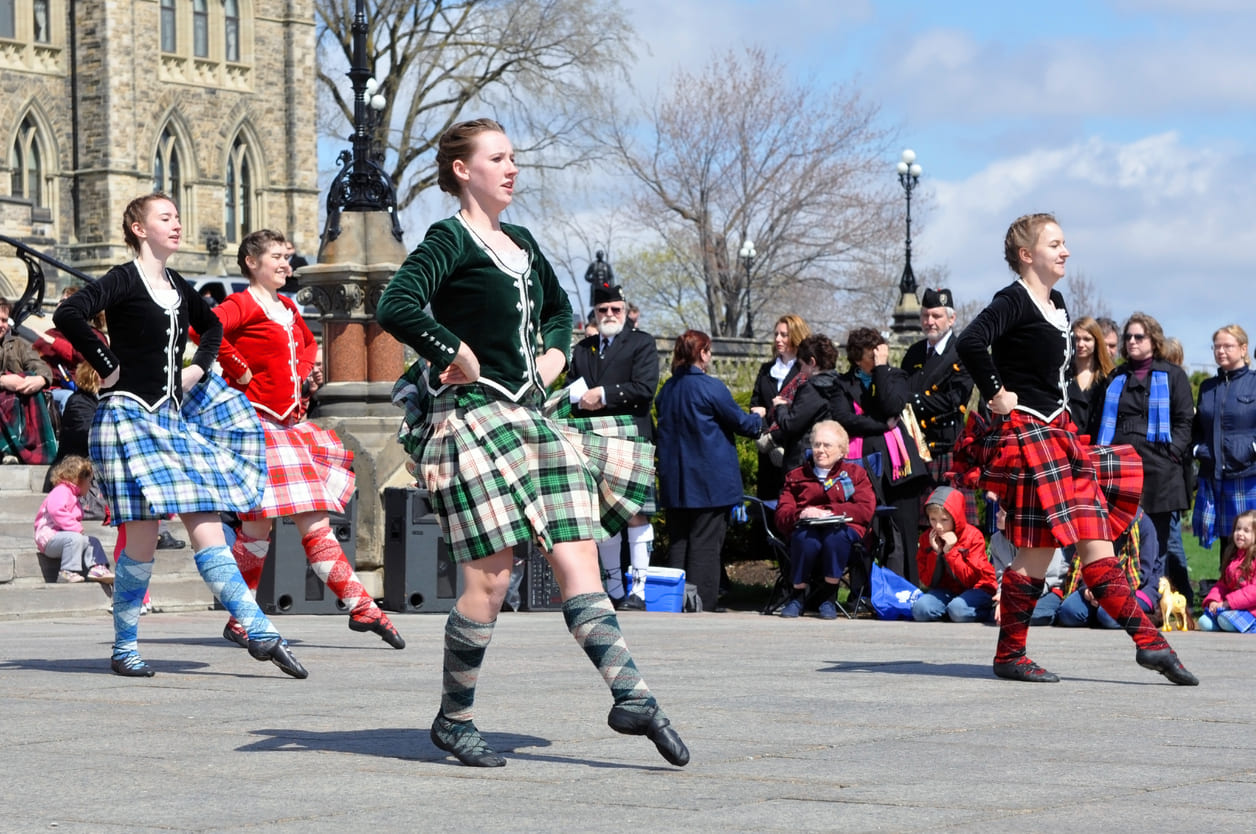 Scottish Highland dancers perform traditional dances in vibrant kilts on Parliament Hill during the Tartan Day celebration in Ottawa.