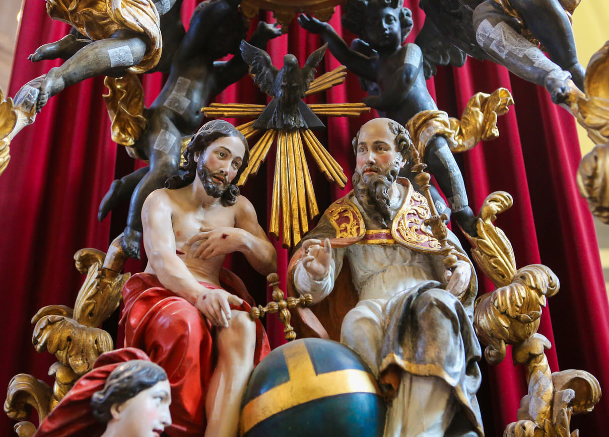 A detailed religious artwork depicting the Holy Trinity, with God the Father, Jesus Christ, and the Holy Spirit, symbolizing the significance of Trinity Sunday.