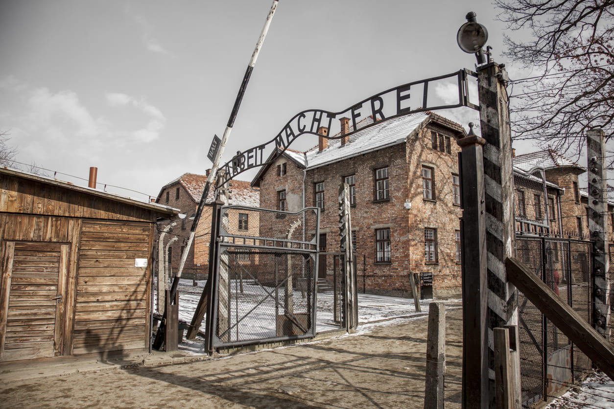 The entrance to Auschwitz, bearing the infamous sign, stands as a chilling reminder of the Holocaust's atrocities.