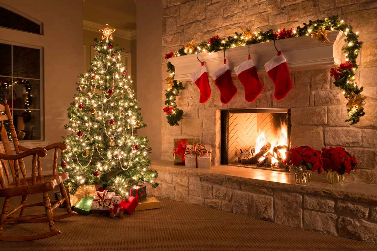 A festive Christmas scene with a decorated tree, glowing fireplace, and hanging stockings.