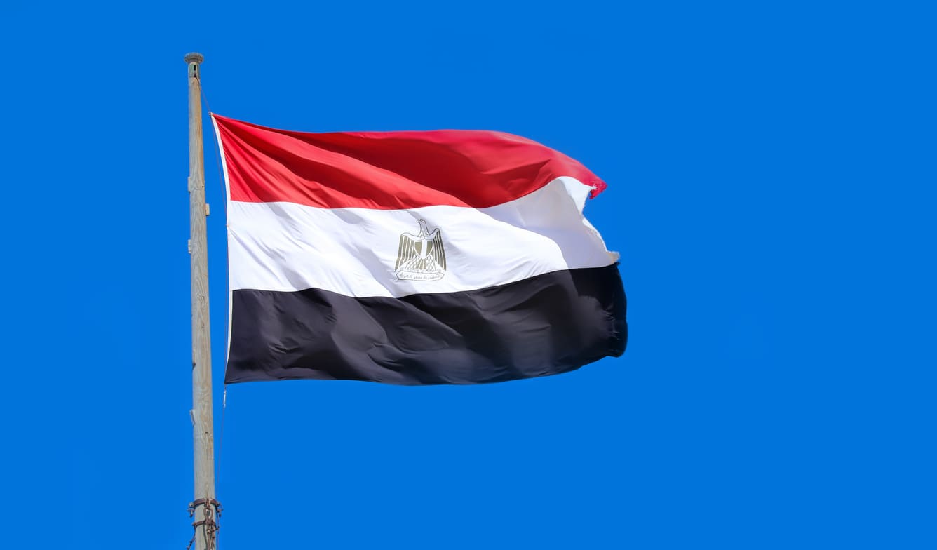 The Egyptian flag soaring against a clear blue sky, symbolizing national pride and the spirit of Sinai Liberation Day.