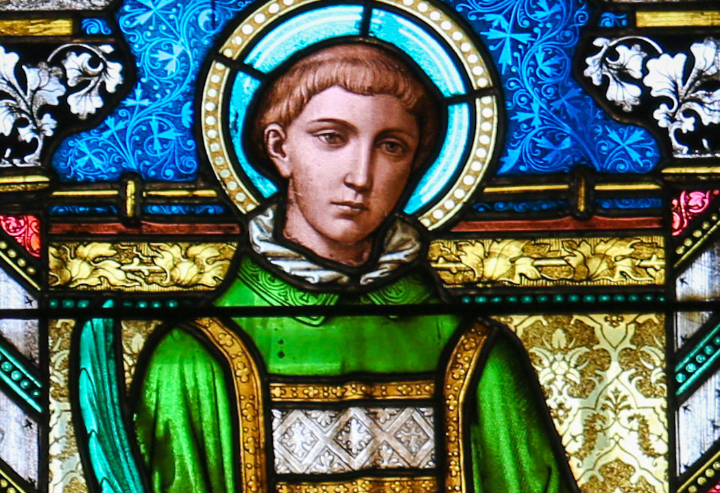 A stained glass portrait of Saint Stephen in green robes, reflecting his role as a dedicated deacon and early Christian leader.
