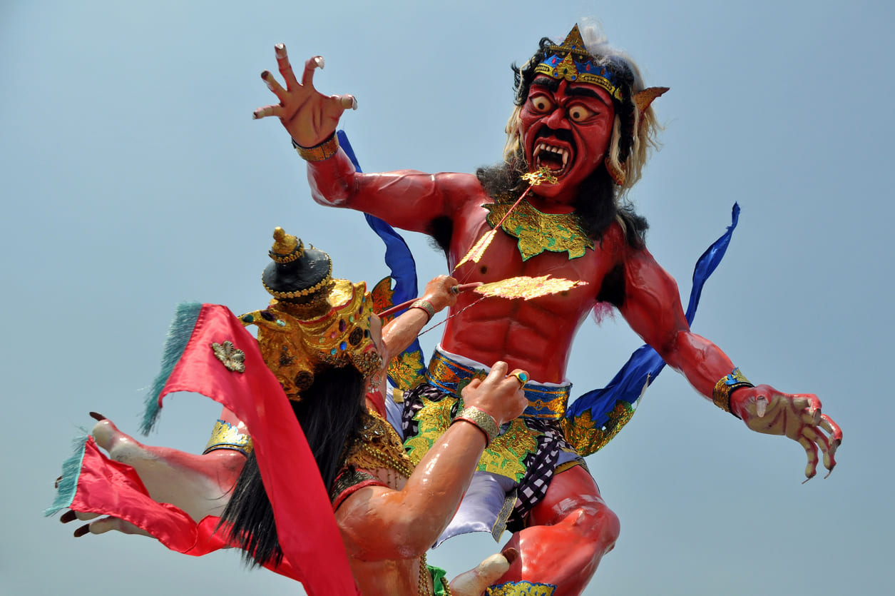 A colorful statue of Lord Rama aiming an arrow at Ravana, symbolizing the epic battle between good and evil.