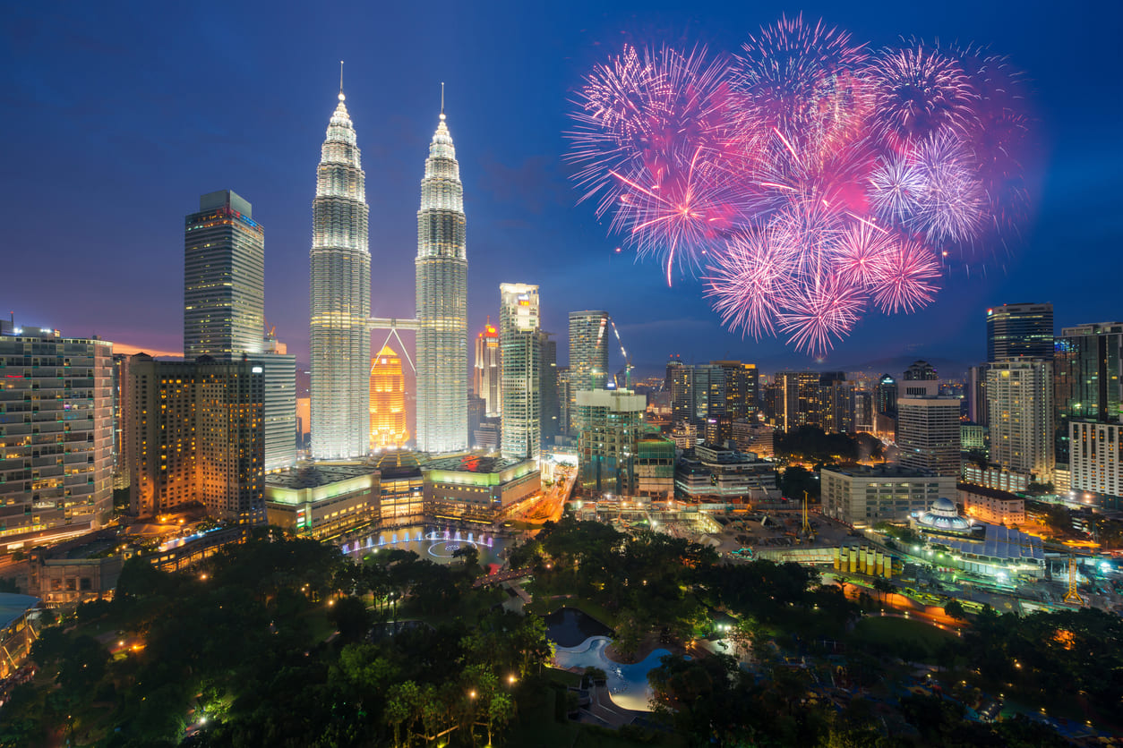 Kuala Lumpur's skyline during New Year's Day, glowing with fireworks as Malaysians celebrate with joy, unity, and hope for the year ahead.