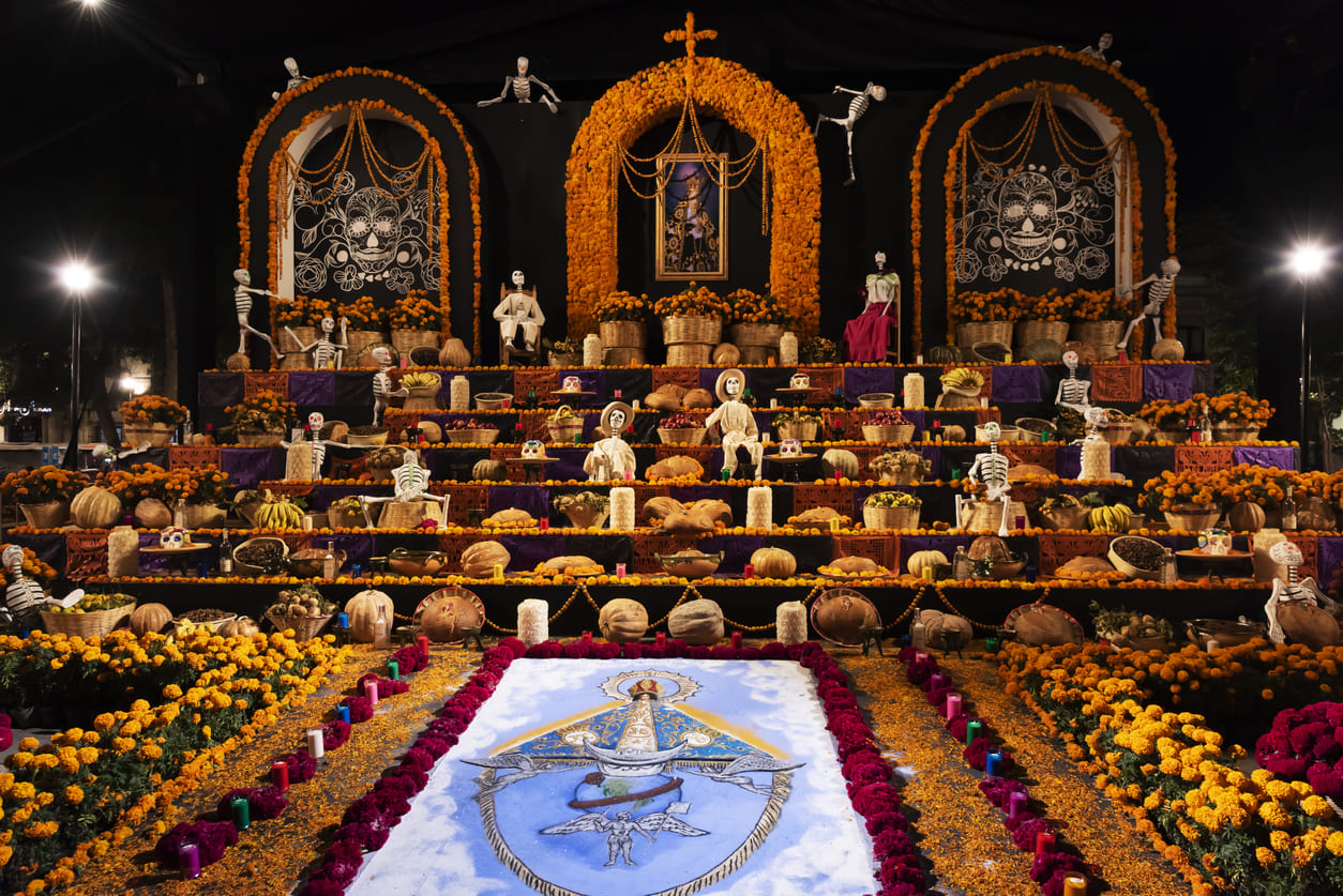 A vibrant altar decorated with marigolds, candles, and offerings, capturing the spirit of the Day of the Dead in Oaxaca.
