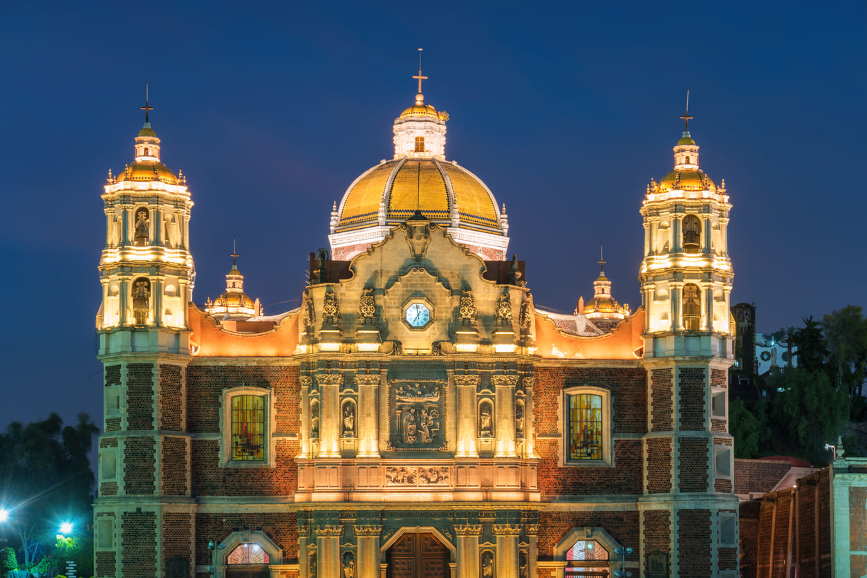 The Basilica of Our Lady of Guadalupe in Mexico City, beautifully illuminated at night, a key destination for pilgrims during the Day of the Virgin of Guadalupe.