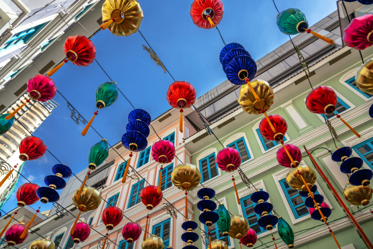 Colorful lanterns hanging above the streets of Manila's Chinatown, creating a festive and lively atmosphere for Chinese New Year celebrations.