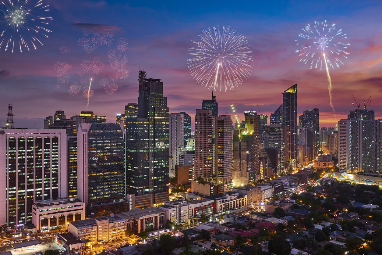 A vibrant Manila skyline illuminated by fireworks, capturing the festive spirit of New Year's Day celebrations in the Philippines.