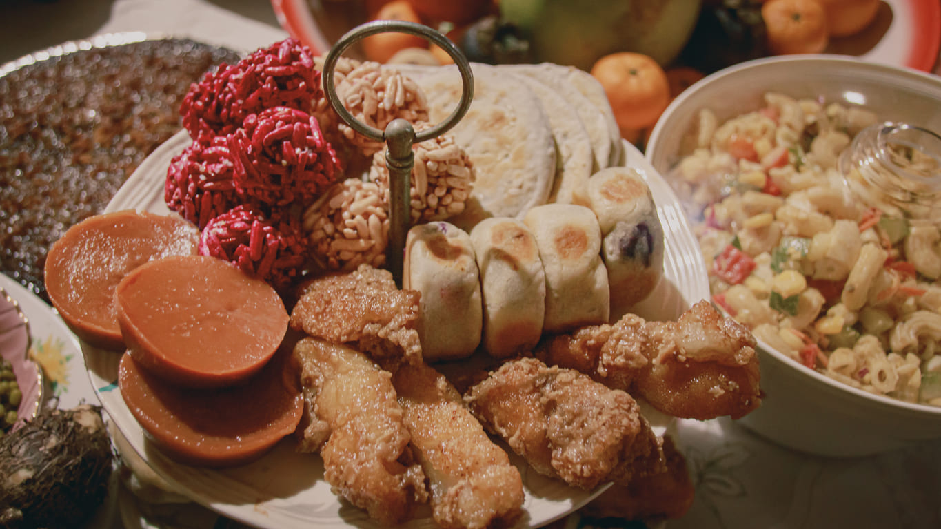 A vibrant Media Noche table filled with traditional Filipino dishes and fruits, prepared to celebrate New Year's Eve with family and good fortune.