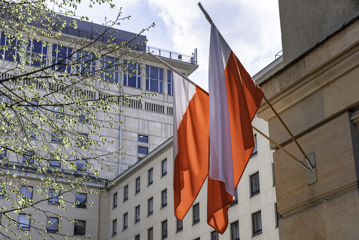 Polish flags waving on a building, symbolizing national pride and celebration of Day of the Flag (Dzień Flagi).