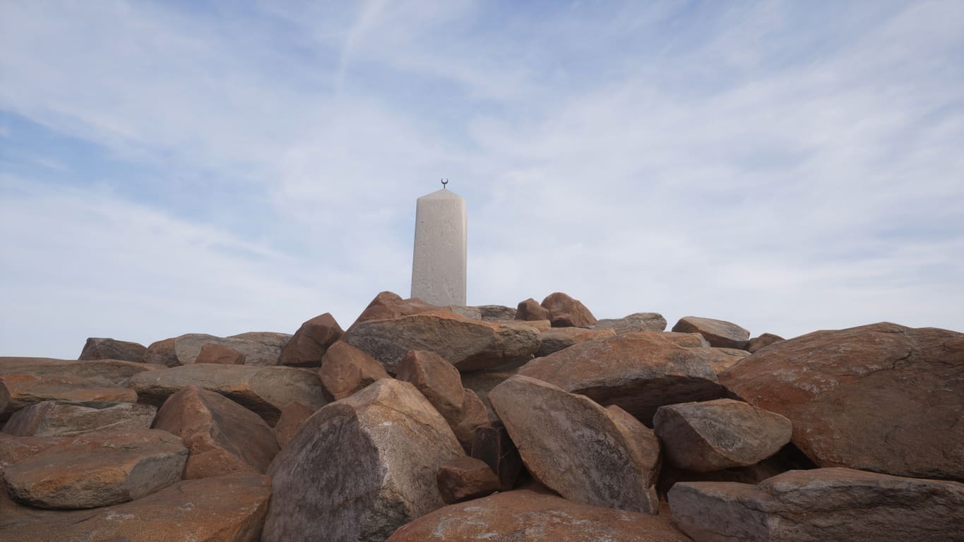 The white monument atop Mount Arafat, a sacred site where Hajj pilgrims gather for worship on Arafat Day.