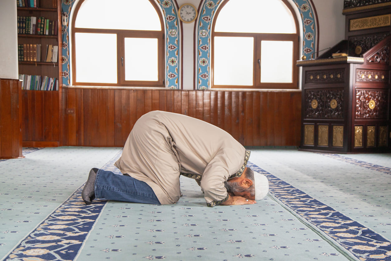 A man in prayer inside a mosque, capturing the quiet devotion often seen during Muharram.