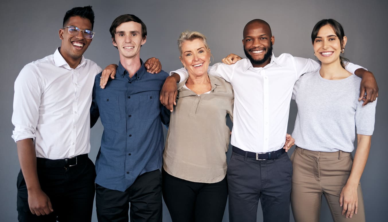 A diverse group of smiling people standing arm in arm, symbolizing unity, friendship, and shared humanity.