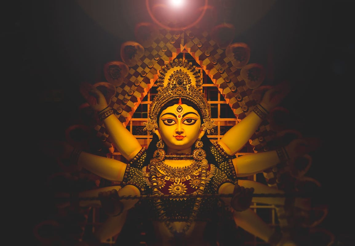 A beautifully crafted idol of Goddess Durga, adorned with ornaments and surrounded by soft light, captures the divine essence of Navaratri.