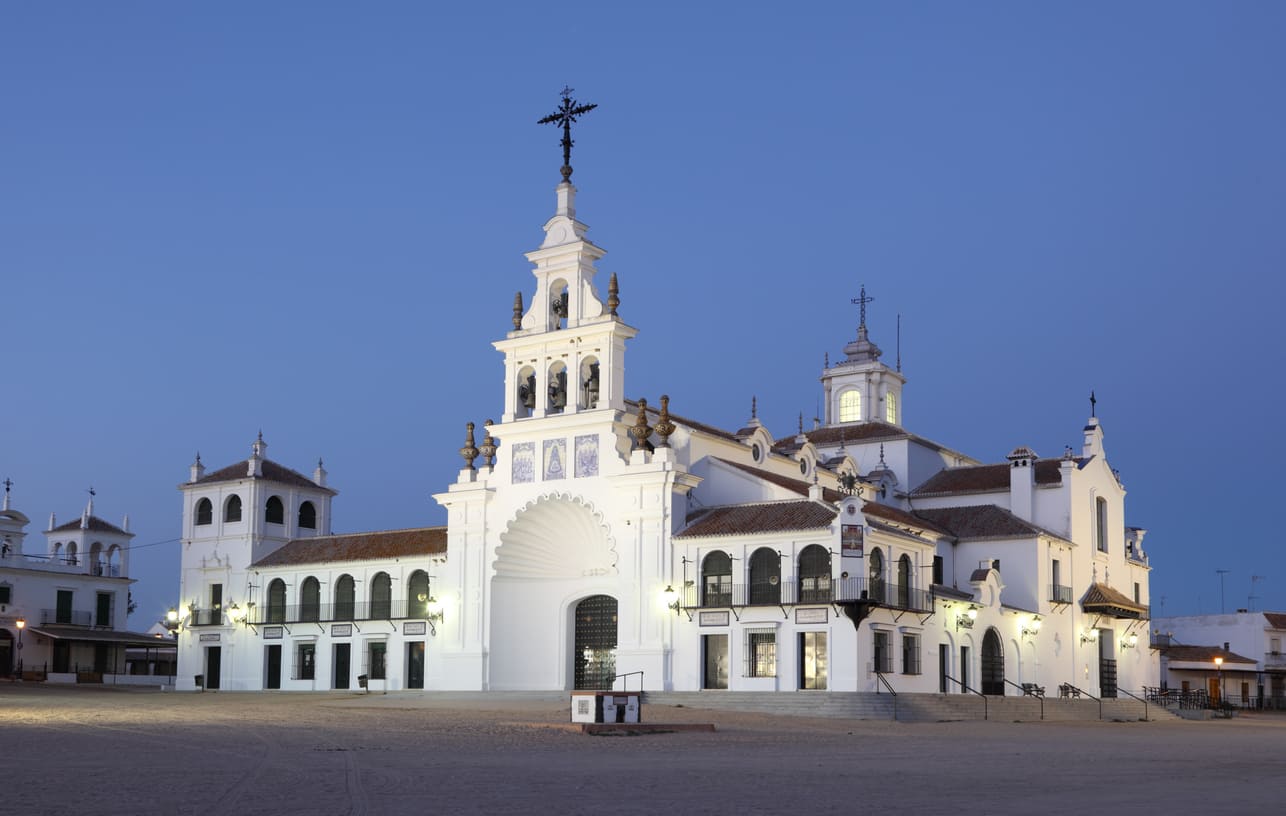 The Hermitage of El Rocío in Andalusia, a historic white-washed church that serves as the focal point of the El Rocío Pilgrimage, a major Pentecost celebration in Spain.