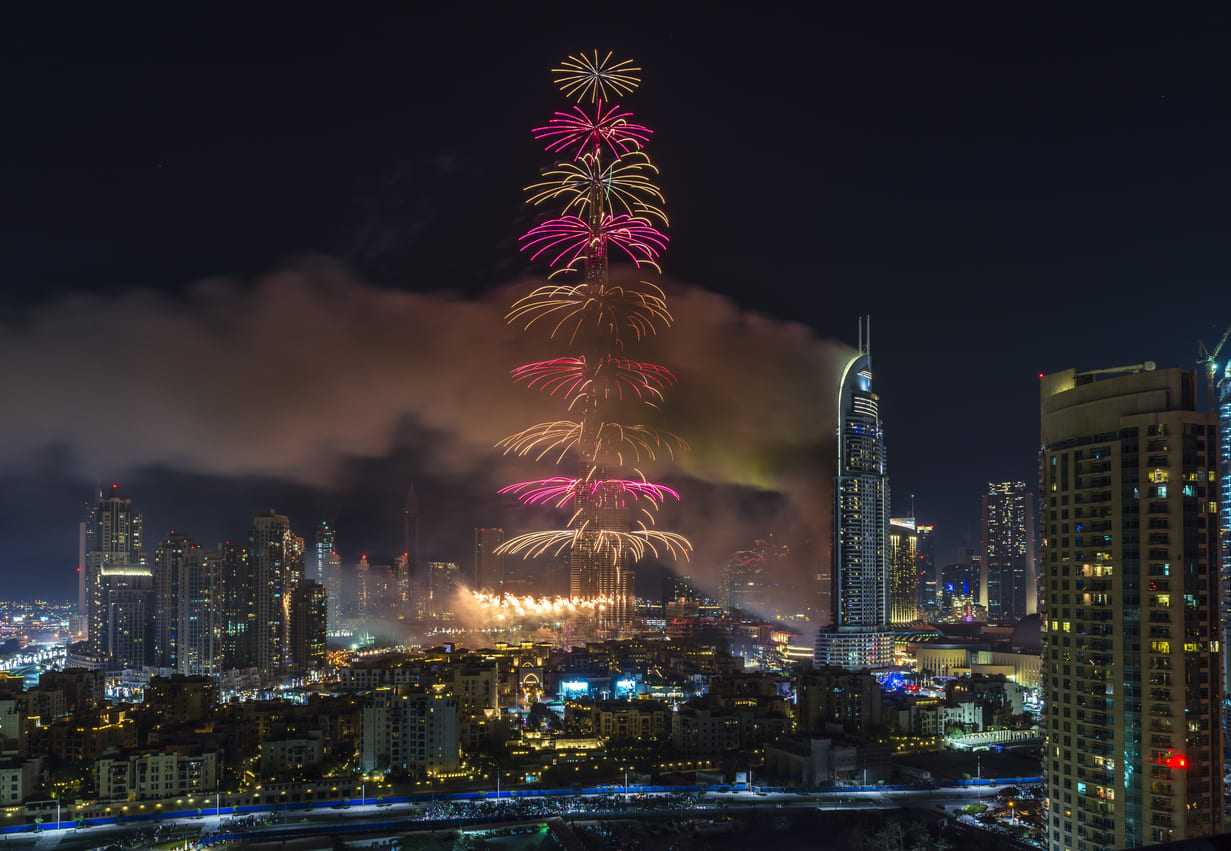 Fireworks erupting from the Burj Khalifa, lighting up the night sky and celebrating the arrival of New Year's Day in Dubai.