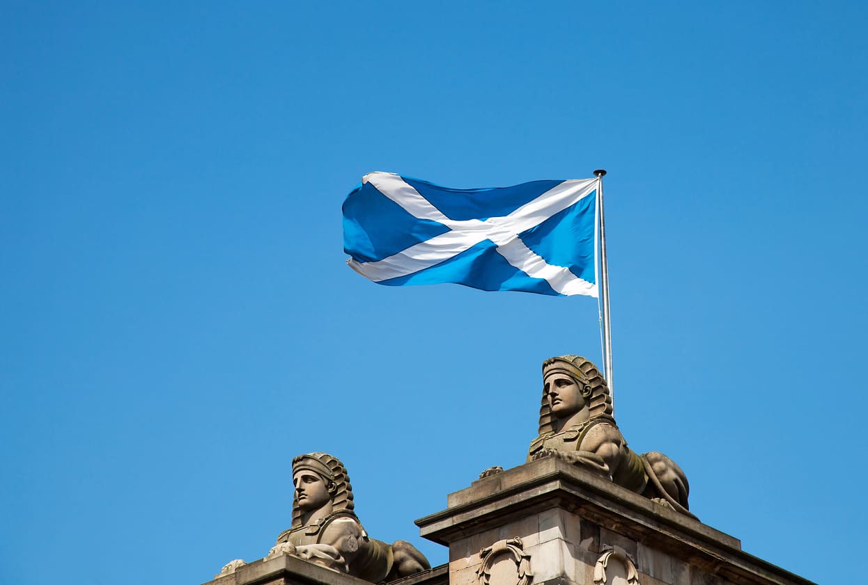 Scottish Saltire flying atop a building, symbolizing Scotland's heritage and pride, often highlighted during St. Andrew's Day celebrations.